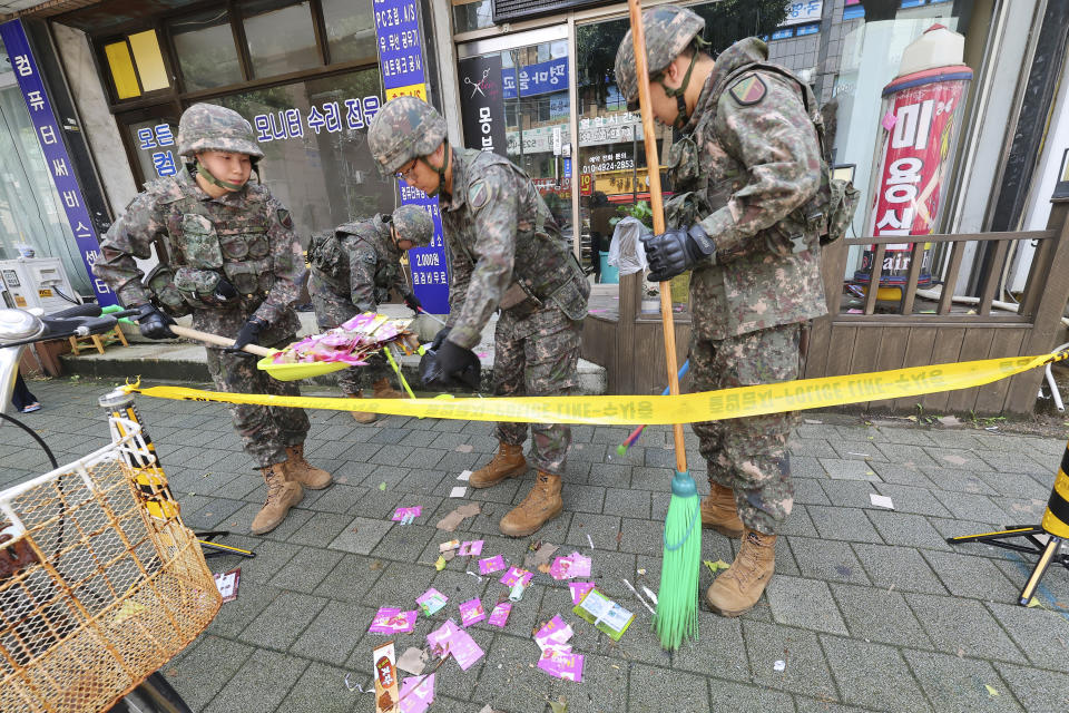 South Korean army soldiers collect the trash from a balloon presumably sent by North Korea, in Incheon, South Korea, Wednesday, July 24, 2024. (Lim Sun-suk//Yonhap via AP)