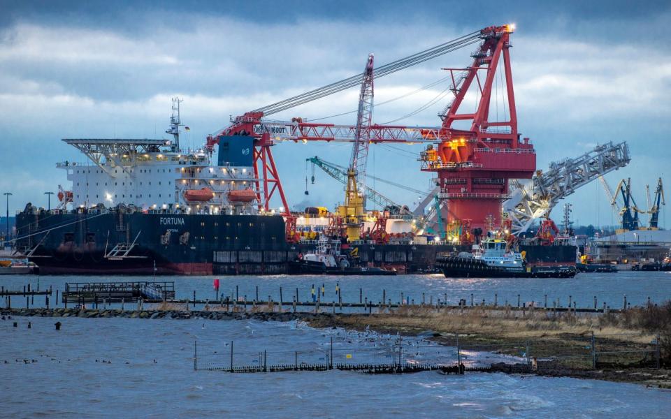 FILE - In this Jan. 14, 2021 file photo, Tugboats get into position on the Russian pipe-laying vessel "Fortuna" in the port of Wismar, Germany, Thursday, Jan 14, 2021. The special vessel is being used for construction work on the German-Russian Nord Stream 2 gas pipeline in the Baltic Sea. The company building a disputed Russian-German subsea pipeline says work on the gas pipeline has resumed, the German news agency dpa reports. Construction on the Nord Stream 2 pipeline was resumed late Saturday, dpa reported Sunday. ( Jens Buettner/dpa via AP, File) -  Jens Buettner/DPA