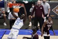 Memphis center Moussa Cisse (32) dunks the ball as Mississippi State forward Abdul Ado, center, and guard Iverson Molinar (1) look on in the first half of an NCAA college basketball championship game in the NIT, Sunday, March 28, 2021, in Frisco, Texas. (AP Photo/Tony Gutierrez)