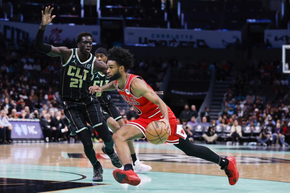 Chicago Bulls guard Coby White, right, drives past Charlotte Hornets forward JT Thor (21) during the first half of an NBA basketball game in Charlotte, N.C., Thursday, Jan. 26, 2023. (AP Photo/Nell Redmond)