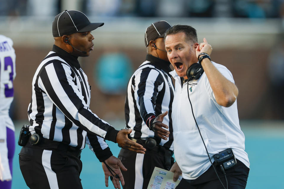 Coastal Carolina head coach Tim Beck argues with officials after his team was called for a penalty during the first half of an NCAA college football game against James Madison in Conway, N.C., Saturday, Nov. 25, 2023. (AP Photo/Nell Redmond)
