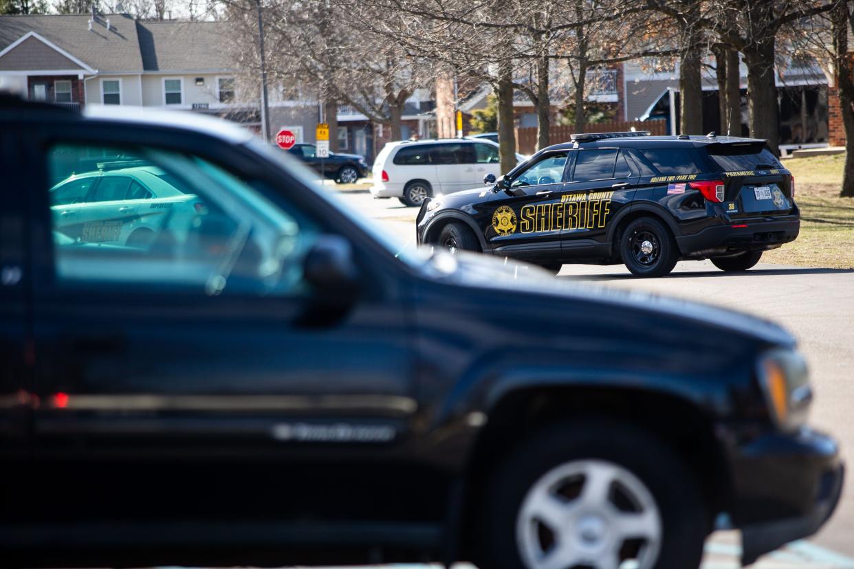 Deputy cars block the drive in front of an apartment during a standoff on March 28, 2022.