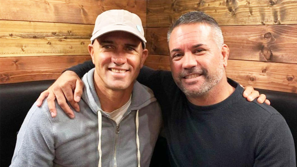 Kelly Slater (pictured left) embraces friend John Shimooka (pictured right).