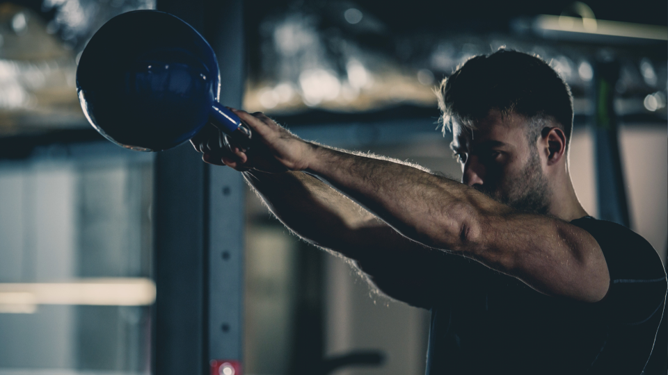 Man doing kettlebell swings