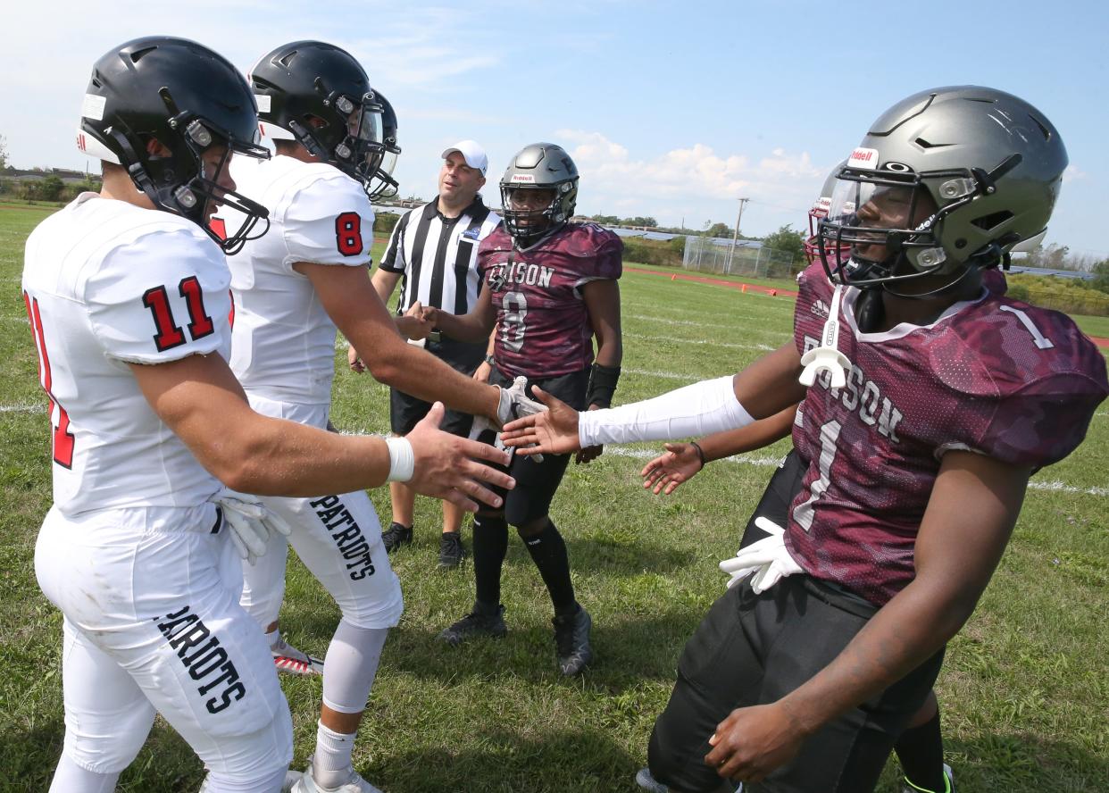 Edison Tech merged captains, from right, Unique Jackson, Clayton Ellington Jr. and Anthony Johnson III, shake hands with Penfield captains, from left, Austin Dillenbeck, Alexander Young and Adam Schembri before the coin toss at center field as Edison returned to Section V football in September 2022 after a season off. The Inventors did not field a team the prior season due to a lack of players.