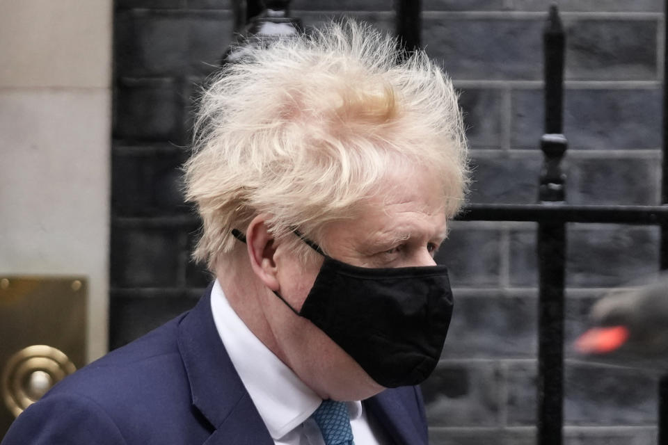 Britain's Prime Minister Boris Johnson leaves 10 Downing Street to attend the weekly Prime Ministers' Questions session in parliament in London, Wednesday, Jan. 26, 2022. Johnson is bracing for the conclusions of an investigation into allegations of lockdown-breaching parties, a document that could help him end weeks of scandal and discontent, or bring his time in office to an abrupt close. (AP Photo/Matt Dunham)