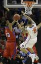 Florida guard Scottie Wilbekin (5) shoots against Dayton forward/center Devon Scott (40) during the second half in a regional final game at the NCAA college basketball tournament, Saturday, March 29, 2014, in Memphis, Tenn. (AP Photo/Mark Humphrey)