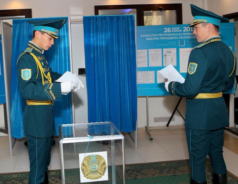 Kazakh servicemen cast their ballot at a polling station in the capital Astana on April 26, 2015