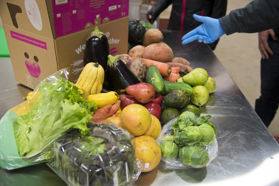 FILE - This Nov. 13, 2018 file photo shows various fruit and vegetables at Imperfect Produce in Severn, Md. The company delivers produce that have been rejected by grocery stores for not fitting cosmetic standards. (Joshua McKerrow/The Baltimore Sun via AP)