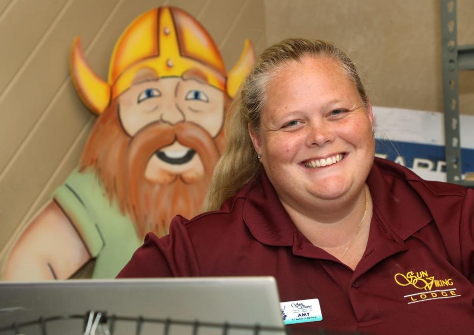 Amy Alexon, general manager at the Sun Viking Lodge in Daytona Beach Shores, smiles at her desk as a Viking cutout watches over her shoulder.  The Sun Viking Lodge is ranked atop a list of the Top 25 Hotels For Families in the United States as part of the 2022 Travelers’ Choice Best of the Best Awards presented by travel website TripAdvisor.com.