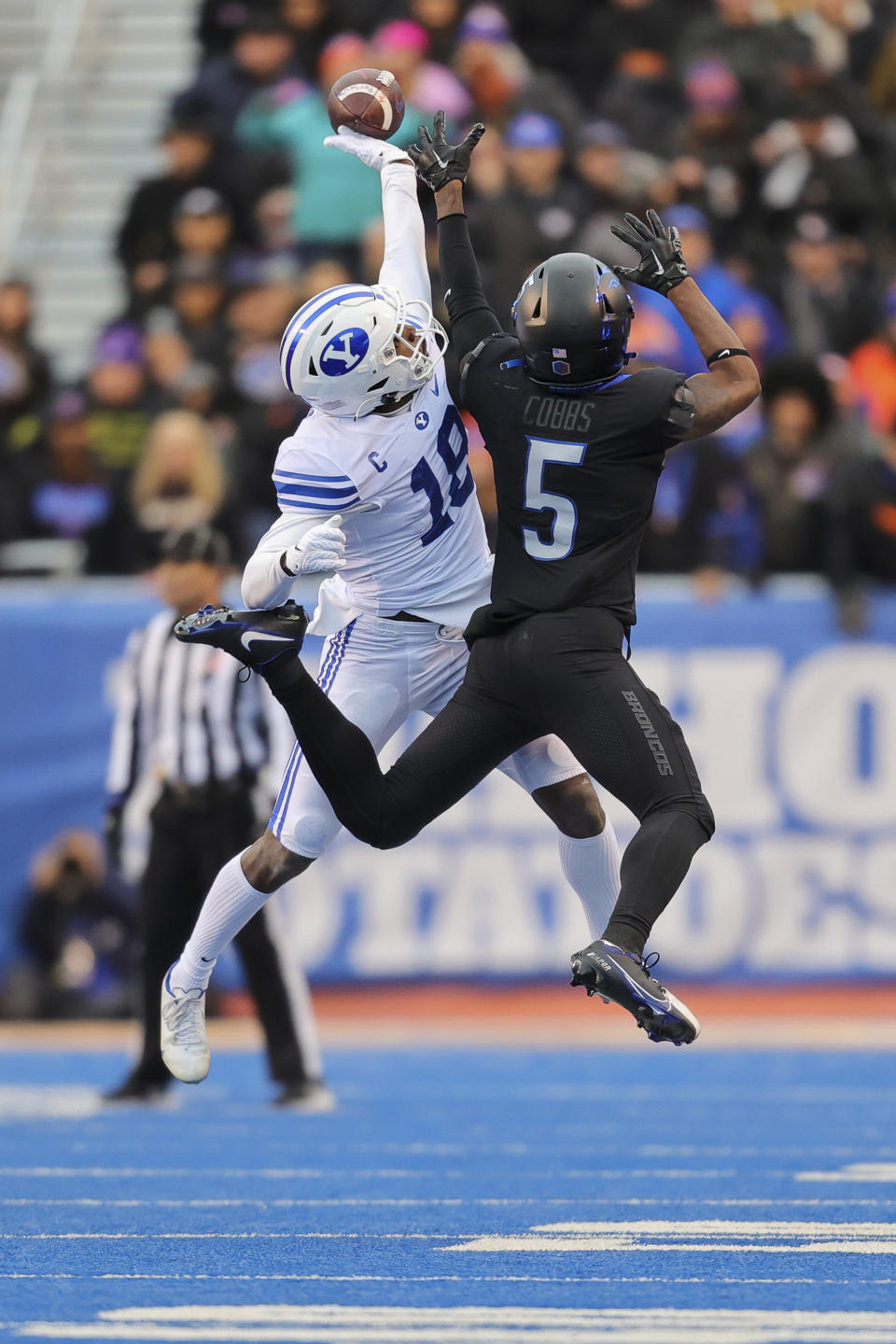 BYU defensive back Kaleb Hayes (18) knocks the ball away from Boise State wide receiver Stefan Cobbs (5) to break up a reception-attempt in the first half of an NCAA college football game, Saturday, Nov. 5, 2022, in Boise, Idaho. (AP Photo/Steve Conner)