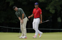 Rory McIlroy of Ireland, left, studies his putt beside Collin Morikawa of United States on the third green during the second round of the men's golf event at the 2020 Summer Olympics on Friday, July 30, 2021, at the Kasumigaseki Country Club in Kawagoe, Japan. (AP Photo/Matt York)