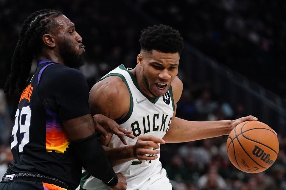 Milwaukee Bucks' Giannis Antetokounmpo tries to get past Phoenix Suns' Jae Crowder during the first half of an NBA basketball game Sunday, March 6, 2022, in Milwaukee . (AP Photo/Morry Gash)