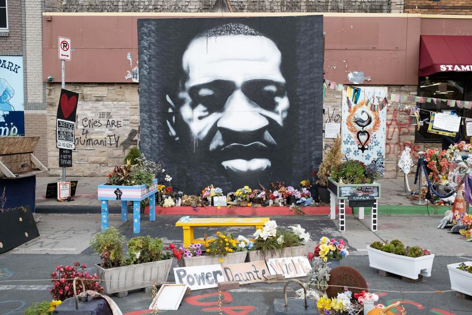 Flowers and signs outside the location of George Floyd's death in Minneapolis, Minnesota in Minneapolis, Minnesota, U.S., on Sunday, Oct. 24, 2021.