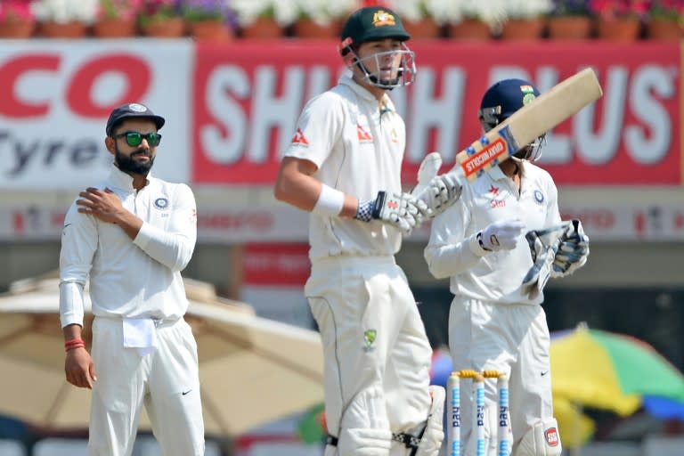 India captain Virat Kohli (L) looks on as Australia batsman Matthew Renshaw bats during the third Test at the Jharkhand State Cricket Association (JSCA) Stadium complex in Ranchi on March 20, 2017