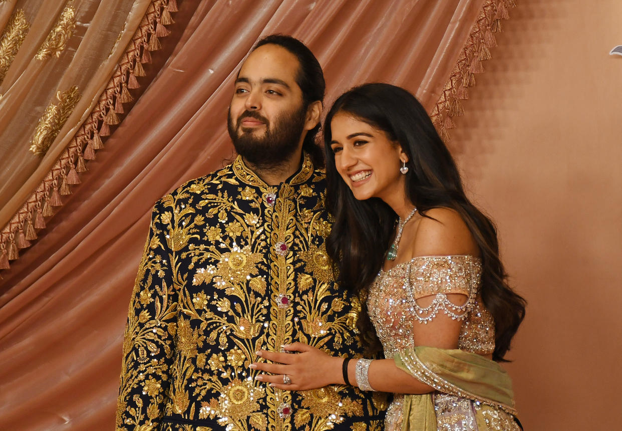 Anant Ambani, son of Indian businessman Mukesh Ambani, and Radhika Merchant wear bejeweled outfits at their wedding. 