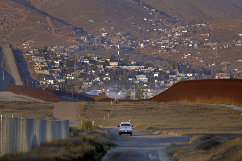 San Diego, California-Aug. 10, 2022-A U.S. Border Patrol agent patrols along the U.S. - Mexico border east of Otay Mesa, San Diego, California on Aug. 10, 2022. (Carolyn Cole / Los Angeles Times)