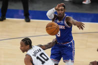 New York Knicks' RJ Barrett (9) passes away from San Antonio Spurs' DeMar DeRozan (10) during the second half of an NBA basketball game Thursday, May 13, 2021, in New York. (AP Photo/Frank Franklin II, Pool)