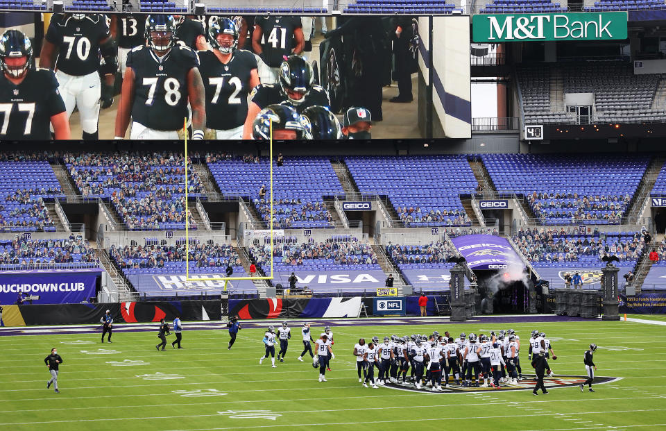 The Titans gathered on the Ravens' logo before Sunday's win. (Rob Carr/Getty Images)