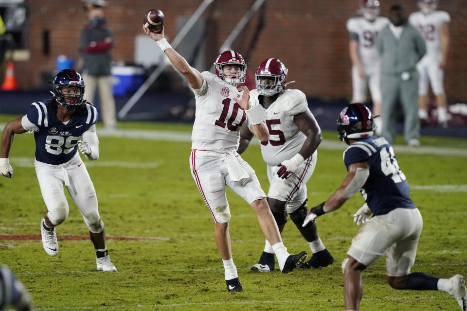 Alabama quarterback Mac Jones (10) passes while being pursued by Mississippi defensive end Ryder Anderson (89) during the second half of an NCAA college football game in Oxford, Miss., Saturday, Oct. 10, 2020. Alabama won 63-48. (AP Photo/Rogelio V. Solis)