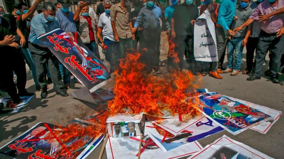 Gente quemando fotos de Trump, Netanyahu y líderes de EAU y Bahréin.