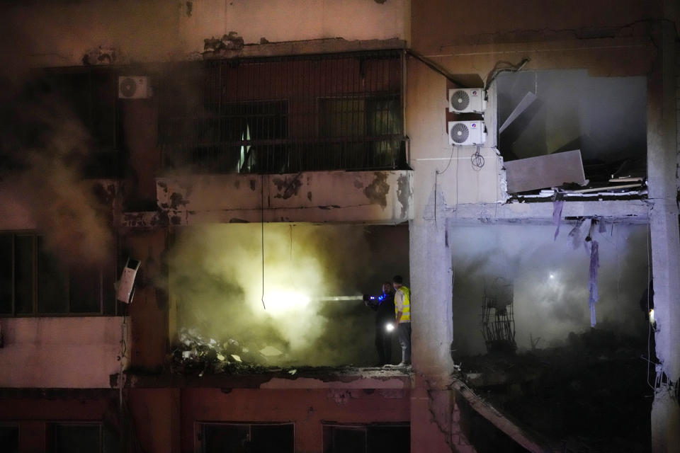 Civil defense workers search for survivors inside an apartment following a massive explosion in the southern suburb of Beirut, Lebanon, Tuesday, Jan. 2, 2024. The TV station of Lebanon's Hezbollah group says top Hamas official Saleh Arouri was killed Tuesday in an explosion in a southern Beirut suburb.(AP Photo/Hussein Malla)