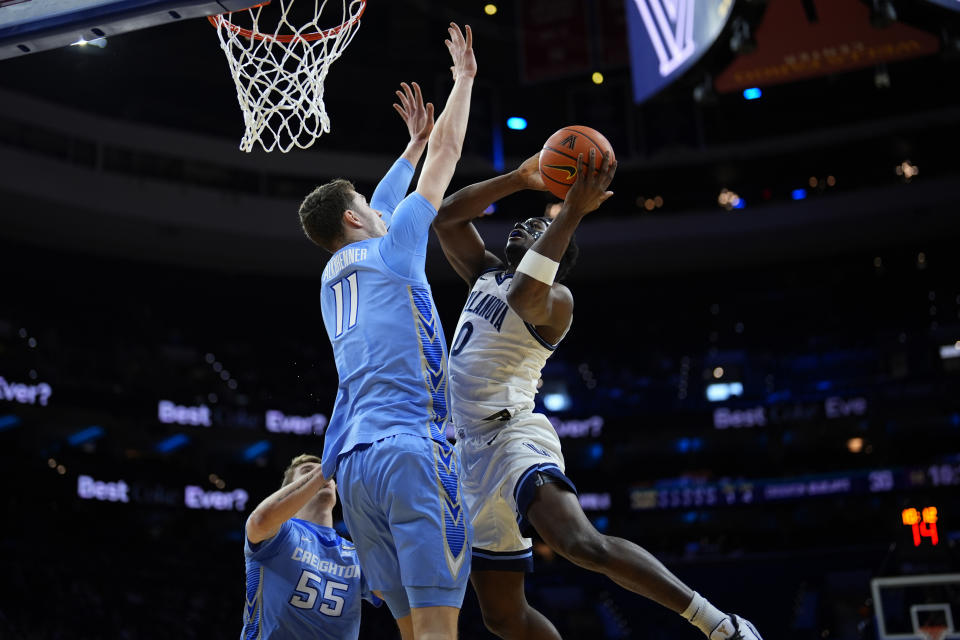 Villanova's TJ Bamba, right, goes up for a shot against Creighton's Ryan Kalkbrenner during the first half of an NCAA college basketball game, Saturday, March 9, 2024, in Philadelphia. (AP Photo/Matt Slocum)