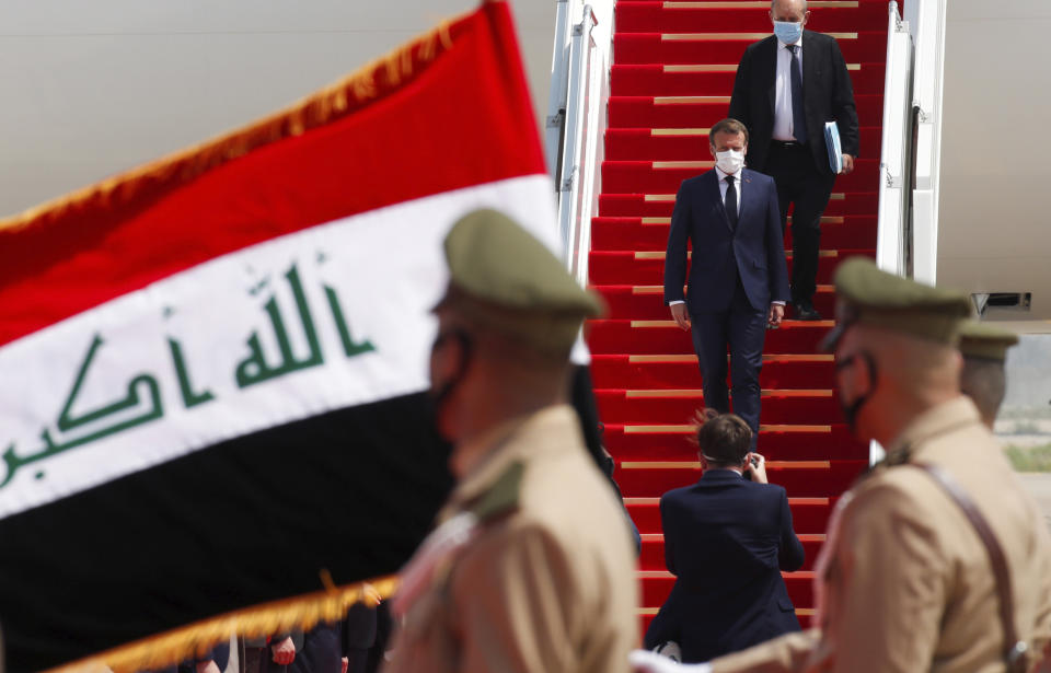 French President Emmanuel Macron gets off a plane as he arrives at Baghdad airport, Iraq, Wednesday, Sept. 2, 2020. Macron is the first head of state to visit the Iraqi capital since Prime Minister Mustafa al-Kadhimi, Iraq's former intelligence chief, formed a new government in May. (Gonzalo Fuentes/Pool via AP)