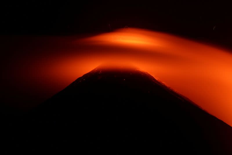 FILE PHOTO: Streams of red hot lava shoot into the night sky during an eruption of the Pacaya volcano, as seen from Los Rios