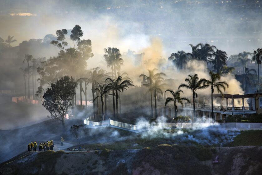 Laguna Niguel, CA - May 12: A view of homes still smoldering from the Coastal fire as seen from Talavera Drive on Thursday, May 12, 2022 in Laguna Niguel, CA. (Irfan Khan / Los Angeles Times)