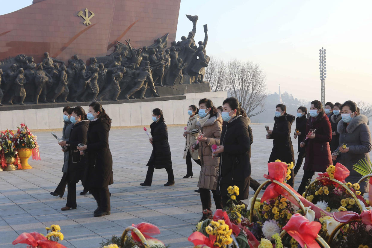 Pyongyang citizens visit Mansu Hill to pay respect to the statues of their late leaders Kim Il Sung and Kim Jong Il on the occasion of the 75th founding anniversary of the Korean People's Army in Pyongyang, North Korea Wednesday, Feb. 8, 2023. (AP Photo/Cha Song Ho)