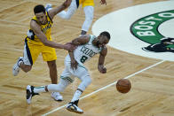 Boston Celtics guard Kemba Walker (8) dribbles the ball upcourt as he is grabbed by Indiana Pacers guard Malcolm Brogdon (7) in the fourth quarter of an NBA basketball game, Friday, Feb. 26, 2021, in Boston. (AP Photo/Elise Amendola)