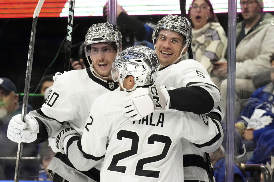 Los Angeles Kings' Andreas Englund, right, celebrates with Kevin Fiala (22) and Pierre-Luc Dubois after scoring against the Toronto Maple Leafs during the first period of an NHL hockey game, Tuesday, Oct. 31, 2023 in Toronto. (Chris Young/The Canadian Press)