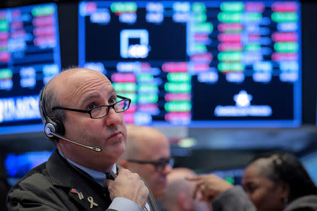 FILE PHOTO: Traders work on the floor of the New York Stock Exchange (NYSE) in New York, U.S., December 10, 2018. REUTERS/Brendan McDermid/File Photo