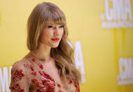 Taylor Swift arrives at the 46th Annual Country Music Awards at the Bridgestone Arena on Thursday, Nov. 1, 2012, in Nashville, Tenn. (Photo by Chris Pizzello/Invision/AP)