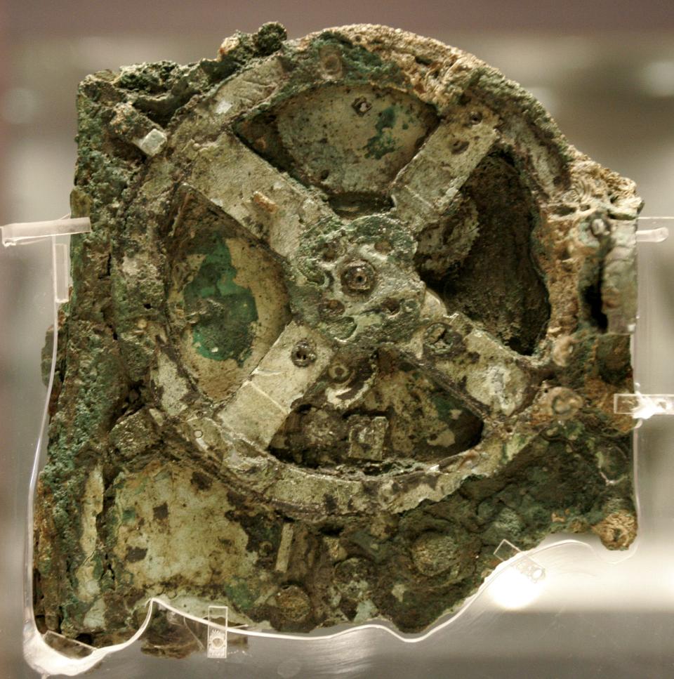 A fragment of the more than 2,000-year-old Antikythera Mechanism, believed to be the earliest surviving mechanical computing device, is seen at the National Archaeological Museum in Athens.