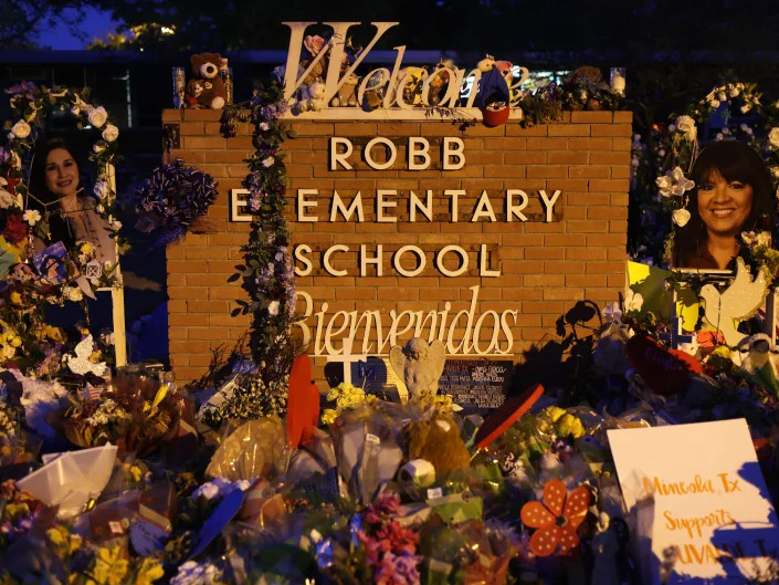 Flowers and photographs are seen at a memorial dedicated to the victims of the mass shooting at Robb Elementary School on June 3, 2022 in Uvalde, Texas.