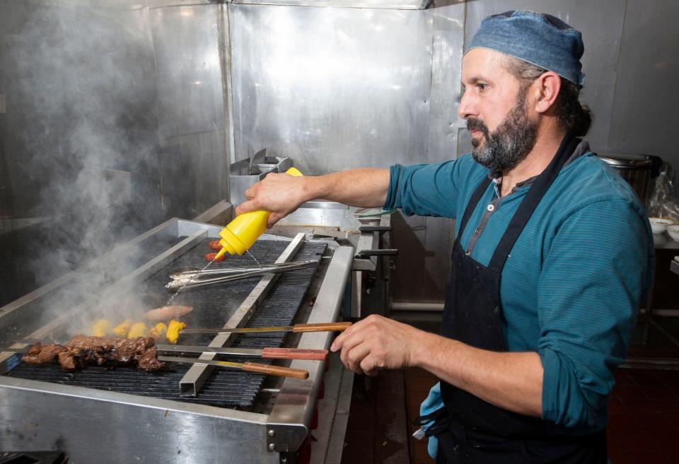 Chef Mohsen Alaruri creates his signature Middle Eastern menu items at the new Beyt Lahm restaurant on West Fairfield Drive on Friday.