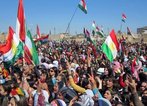 Syrian Kurds wave the Kurdish flag as they rally against the Syrian regime and to mark Nowruz spring festivities in the northern city of Qamishli. The UN Security Council demanded Wednesday that Syria immediately implement a peace plan by special envoy Kofi Annan, even as government forces pounded rebel zones around Damascus and Homs