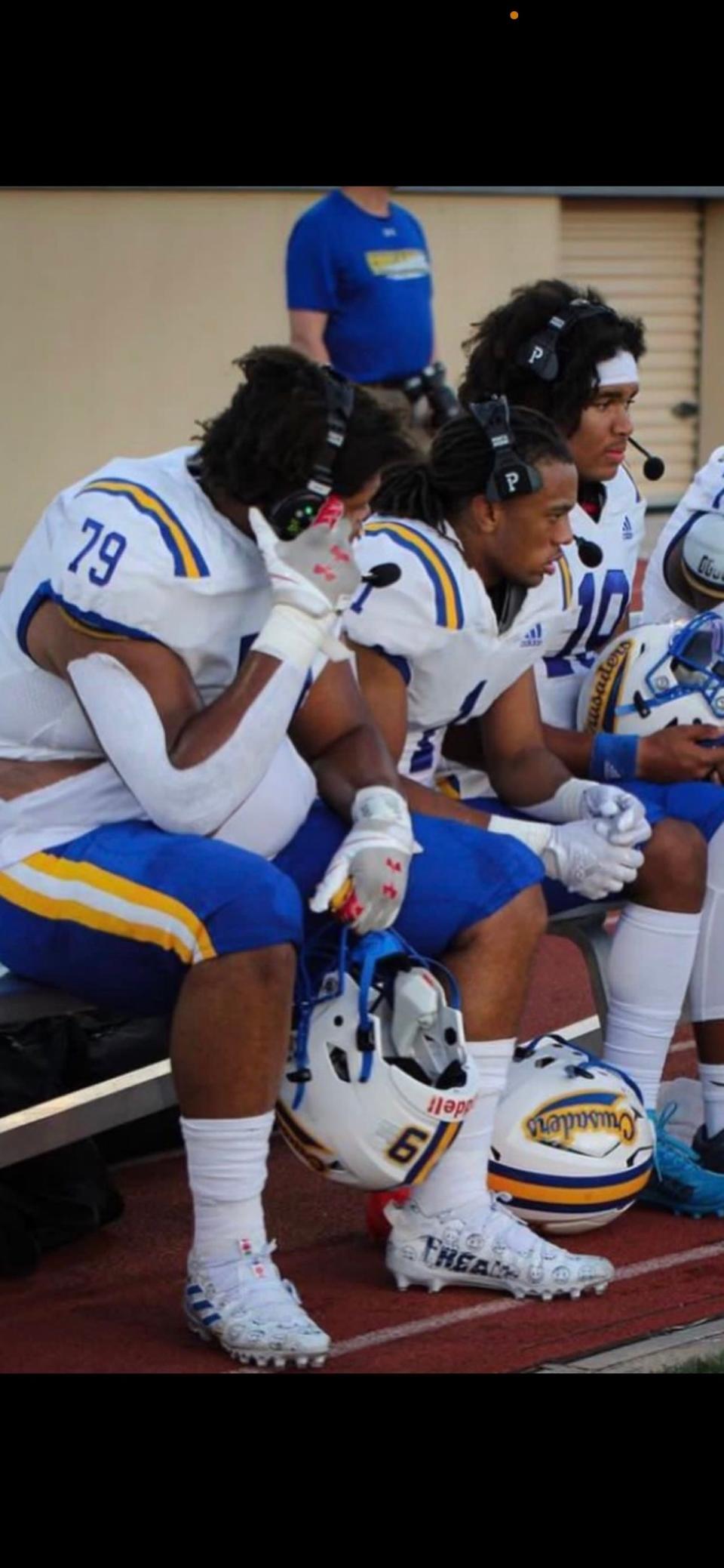 Offensive lineman Donovan Harbour (79) and running back and best friend Corey Smith (1) take a breather on Catholic Memorial High bench last season. The Wisconsin teammates are national level recruits who have verbally committed to play at Penn State.