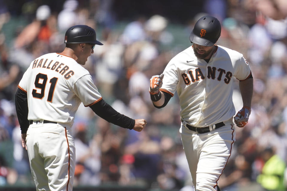 San Francisco Giants' Brandon Belt, right, is congratulated by third base coach Mark Hallberg (91) after hitting a home run against the Arizona Diamondbacks during the seventh inning of a baseball game in San Francisco, Wednesday, July 13, 2022. (AP Photo/Jeff Chiu)