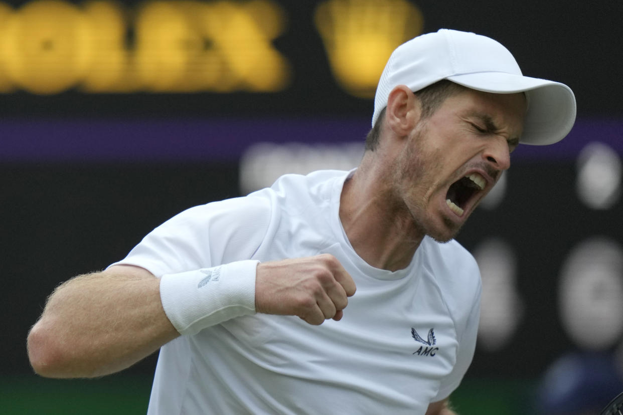 Britain's Andy Murray celebrates winning the third set during the singles tennis match against John Isner of the US on day three of the Wimbledon tennis championships in London, Wednesday, June 29, 2022. (AP Photo/Alastair Grant)