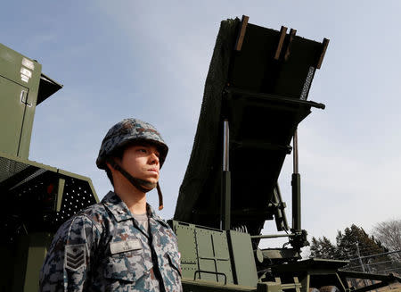 A Japanese Ground Self-Defense Force member stands in front of PAC-3 missile interceptor at Narashino exercise field in Funabashi, east of Tokyo, Japan January 18, 2018. REUTERS/Kim Kyung-Hoon