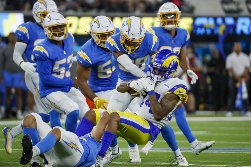 Inglewood, CA, Saturday, August 13, 2022 - Chargers defenders bring down Los Angeles Rams running back A.J. Rose (24) in a preseason game at SoFi Stadium. (Robert Gauthier/Los Angeles Times)