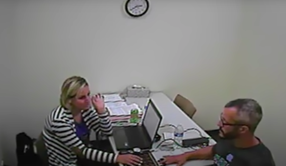 A woman administering a lie detector test on a man