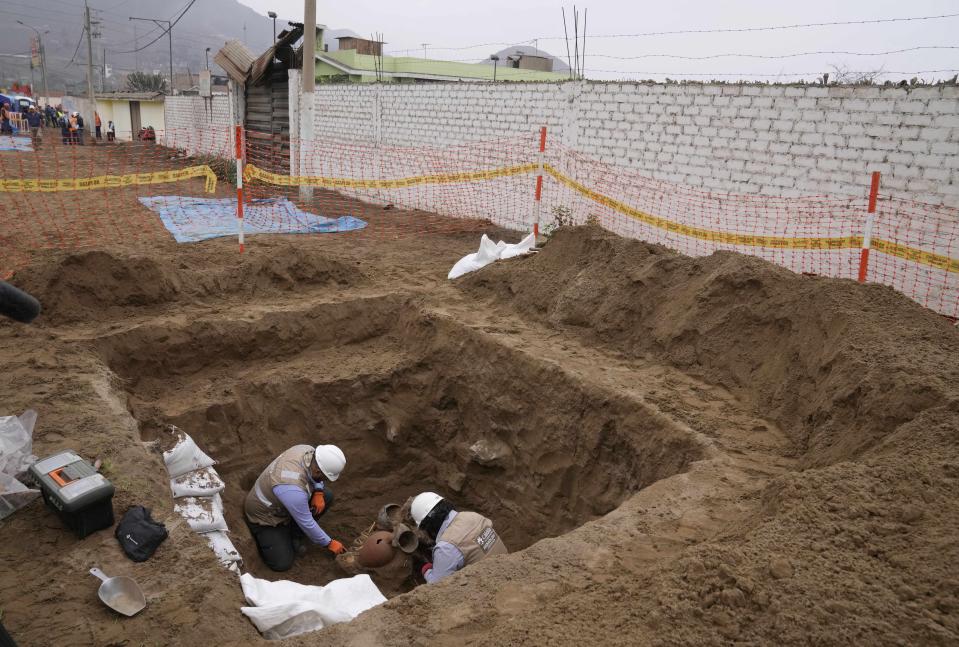 Arqueólogos descubren huesos y vasijas halladas por trabajadores de la ciudad que estaban cavando una tubería de gas natural para la empresa Calidda en el distrito de Carabayllo en las afueras de Lima, Perú, el viernes 22 de septiembre de 2023. (AP Foto/Martín Mejía)