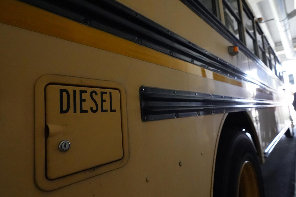 A diesel-powered school bus is shown parked at MAST Academy, Wednesday, Sept. 29, 2021, in Miami. Student Holly Thorpe, 14, urged the Miami-Dade County Public Schools to considering replacing foul-smelling diesel buses with electric vehicles. The school board voted this week to use a state grant to purchase up to 50 electric buses. Miami-Dade is joining a growing number of school districts transitioning from diesel to more environmentally-friendly electric school buses. (AP Photo/Wilfredo Lee)