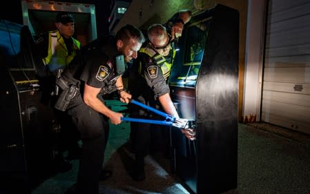 York Regional Police cut the locks on gambling machines seized during raids in an illegal gaming investigation named Project Sindacato are pictured in Vaughan