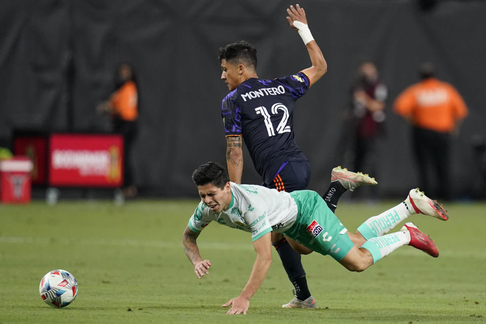 Seattle Sounders' Fredy Montero (12) and Club Leon's Victor Davila (7) battle for the ball during the first half of the Leagues Cup soccer final Wednesday, Sept. 22, 2021, in Las Vegas. (AP Photo/John Locher)