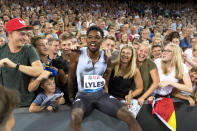 Noah Lyles from the USA reacts together with fans after winning the men's 100m race, during the Weltklasse IAAF Diamond League international athletics meeting in the stadium Letzigrund in Zurich, Switzerland, Thursday, August 29, 2019. (Jean-Christophe Bott/Keystone via AP)